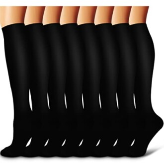 Eight pairs of black knee-high compression socks.