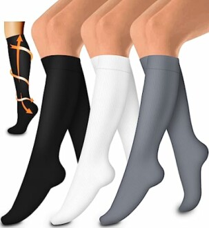 Four pairs of knee-high compression socks in black, white, and gray.