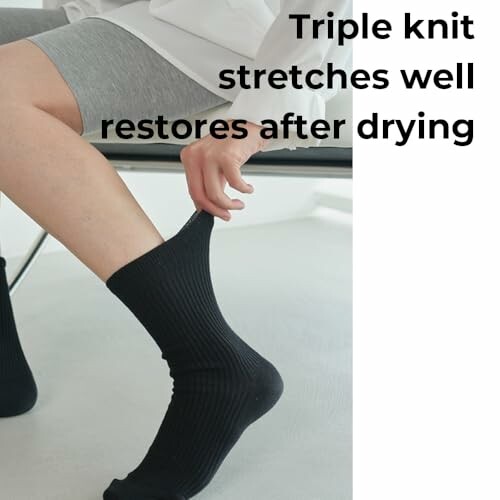 Person sitting and putting on black socks with text about stretch and drying